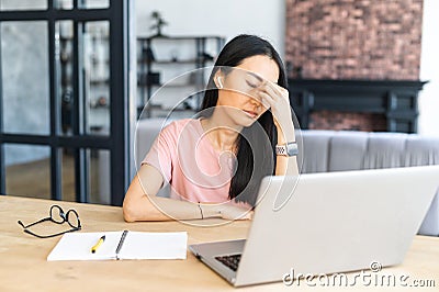 Unhappy businesswoman sit at desk at home Stock Photo