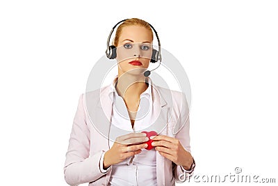 Unhappy call center woman holdinh heart model Stock Photo