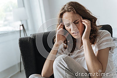 Unhappy cheerless woman having migraine Stock Photo