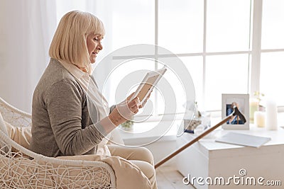 Unhappy cheerless woman looking at the photo Stock Photo