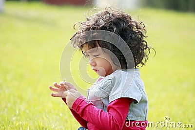 Unhappy child on the grass Stock Photo