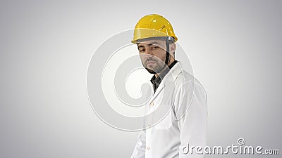 Unhappy construction site engineer talking and walking on gradie Stock Photo