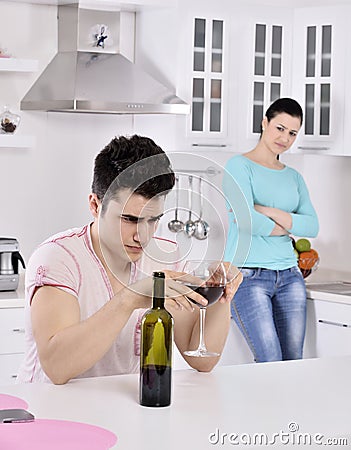 Unhappy couple red vine in the kitchen Stock Photo