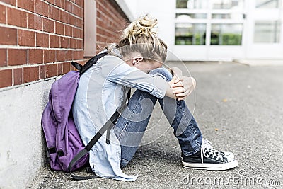 Unhappy Pre teen girl at school Stock Photo
