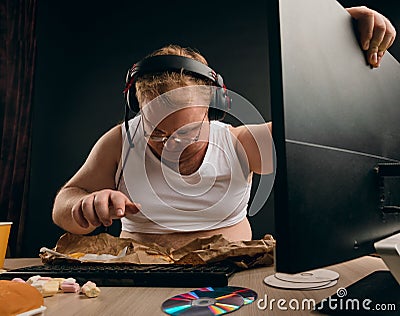 Unhappy fat man trying to fix the computer Stock Photo