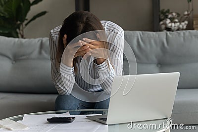 Unhappy frustrated woman holding head, checking bills, debt or bankruptcy Stock Photo