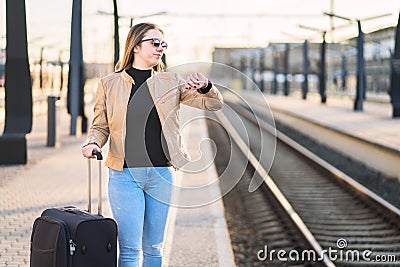 Unhappy and frustrated woman looking at the time and watch. Stock Photo