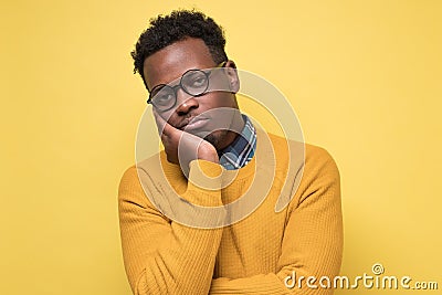 Unhappy frustrated young african man having puzzled expression Stock Photo