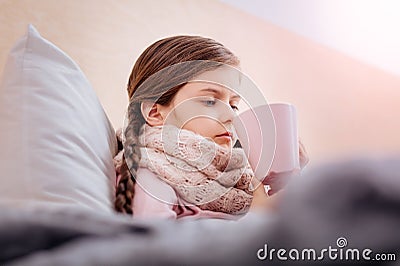 Unhappy girl drinking useful tasteless tea Stock Photo