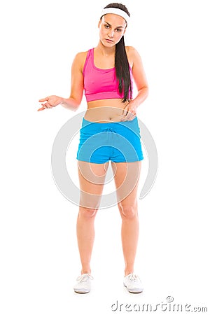 Unhappy girl in sportswear checking body fat Stock Photo