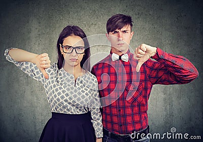 Unhappy grumpy couple giving thumbs down gesture, disagree with something. Stock Photo