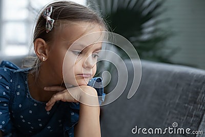 Unhappy little girl look in distance thinking Stock Photo