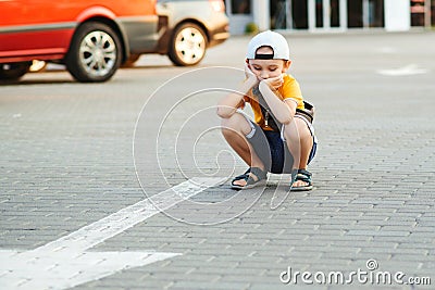 Unhappy lonely child. Boy lost parents at city street Stock Photo