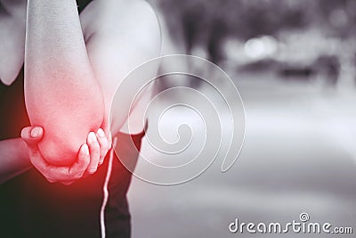 Unhappy man suffering from Sport injury while exercise with Lower holding hands pain in the elbow. image black and white and highl Stock Photo