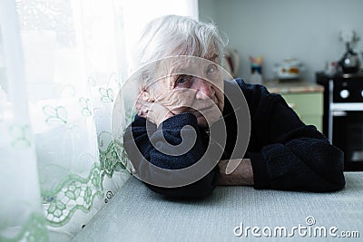 Old ledy portrait near window in the house Stock Photo