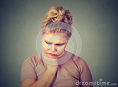 Unhappy overweight woman depressed looking down. Human face expression emotion Stock Photo