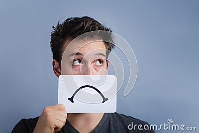 Unhappy Portrait of someone Holding a Sad Mood Board Stock Photo