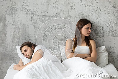 Unhappy sad couple after quarrel ignoring each other in bed Stock Photo