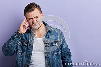 Unhappy sad depressed man toughing his temple, guy has bad memory, man trying remember something Stock Photo