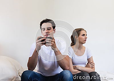 Unhappy & stressed young married couple. Angry offended sullen marriage with depression and disappointtd after argument. Conflict Stock Photo