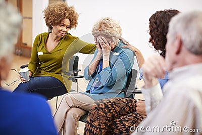 Unhappy Woman Attending Self Help Therapy Group Meeting In Community Center Stock Photo
