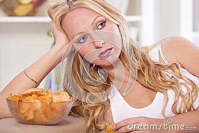 Unhappy woman with chips Stock Photo