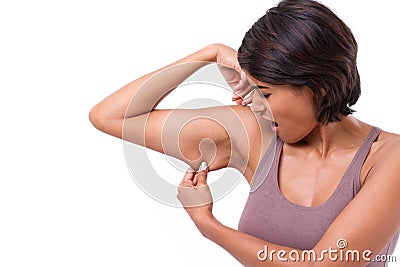 Unhappy woman with hand holding excessive arm fat Stock Photo