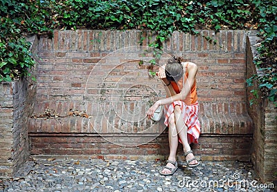 Unhappy woman in orange Stock Photo