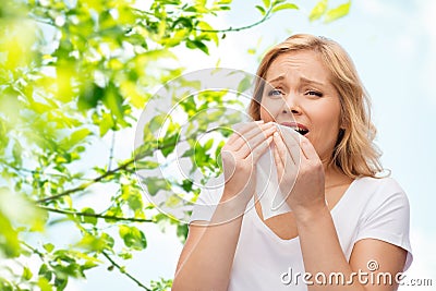 Unhappy woman with paper napkin sneezing Stock Photo