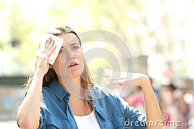 Unhappy woman sweating suffering a heat stroke Stock Photo