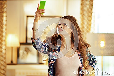 Unhappy woman trying to get better wifi signal on smartphone Stock Photo