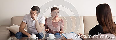 Unhappy young couple consulting family psychologist, arguing, ho Stock Photo