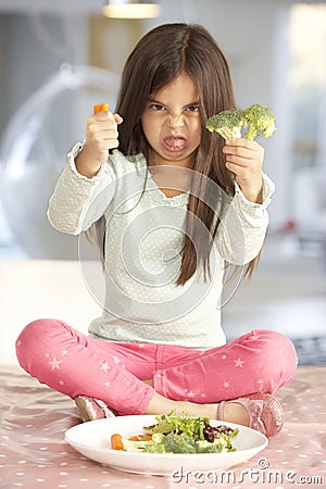 Unhappy Young Girl Rejecting Plate Of Fresh Vegetables Stock Photo
