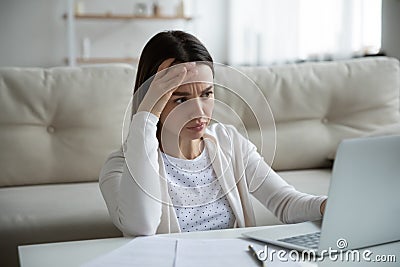 Unhappy woman stressed by slow internet connection on laptop Stock Photo