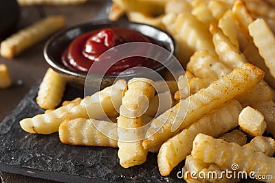 Unhealthy Baked Crinkle French Fries Stock Photo