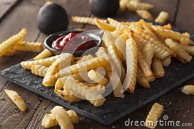 Unhealthy Baked Crinkle French Fries Stock Photo