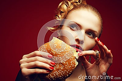 Unhealthy eating. Junk food concept. Portrait of woman eating burger Stock Photo