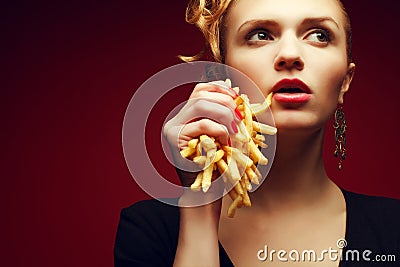 Unhealthy eating. Junk food concept. Portrait of woman with fries Stock Photo