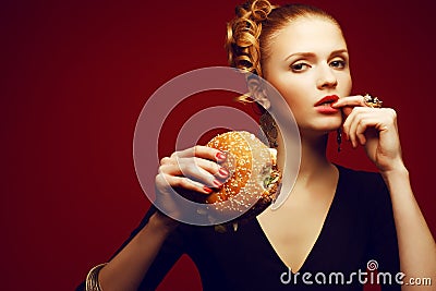 Unhealthy eating. Junk food concept. Woman eating burger Stock Photo