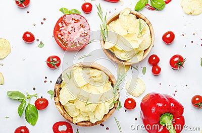 Unhealthy food background, potato chips with salt, tomatoes, chi Stock Photo