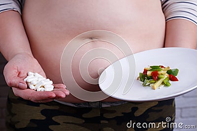 Unhealthy harming ways to lose weight. Slimming pills and ridicu Stock Photo