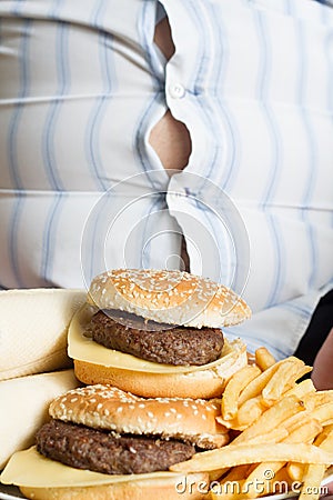 Unhealthy junk fast food and belly of fat man Stock Photo