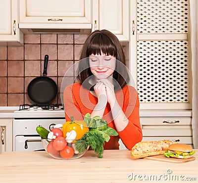 Unhealthy vs healthy food concept woman with vegetables reject Stock Photo