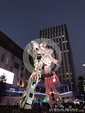 Unicorn Gundam standing in front of the Diver City Tokyo Plaza at Odaiba city at night Editorial Stock Photo