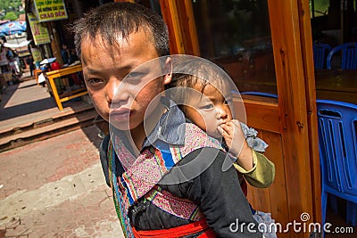 Unidenti Unidentified Hmong Boy Carrying Baby in Sapa, Lao Cai,Vietnam Editorial Stock Photo