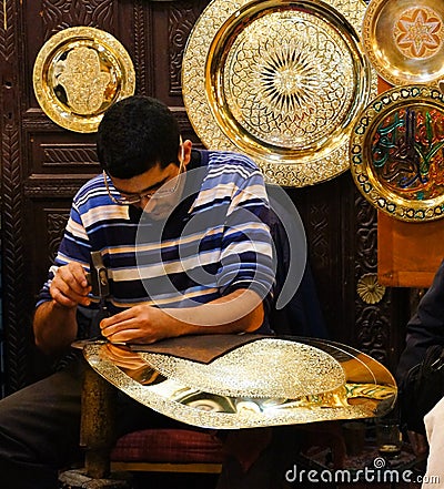 Unidentified Arabic people make traditional metal plate in a mar Editorial Stock Photo