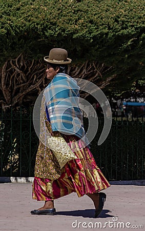 Unidentified bolivian woman wearing traditional clothes walks arround the square in Copacabana, Bolivia Editorial Stock Photo