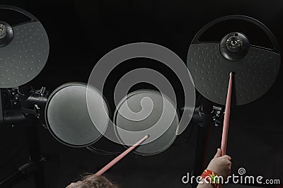 Unidentified Caucasian little girl play electronic drum. Top view Stock Photo