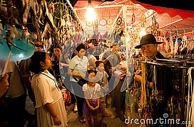 Unidentified children and families walking around thai night market with wind catchers shop Editorial Stock Photo