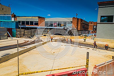 Unidentified construction workers building new Editorial Stock Photo